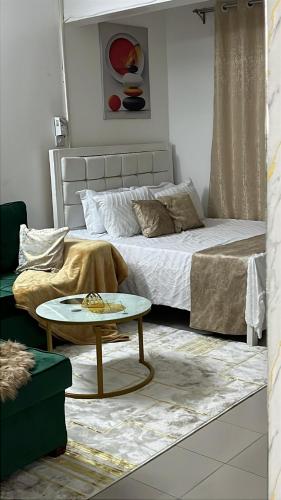 a bedroom with a bed and a coffee table at Yemane luxury Studio in Mombasa