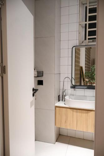 a bathroom with a sink and a mirror at GIA Hotel & Serviced Apartment in Nhơn Trạch
