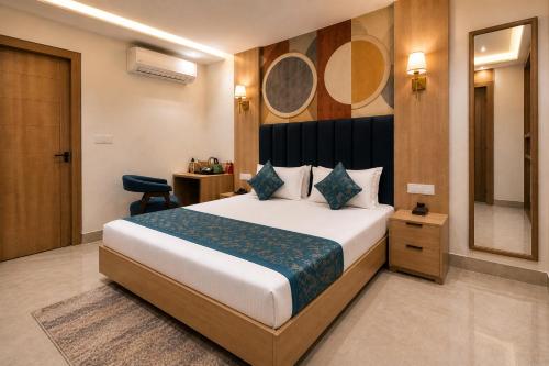 a hotel room with a bed and a mirror at Hotel Velvet The Ultimate in Prayagraj