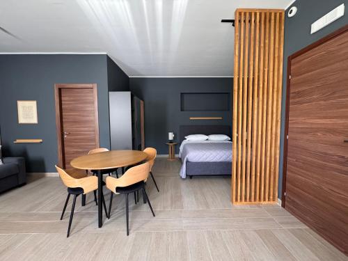 a room with a table and chairs and a bed at Cristina Home in Taranto