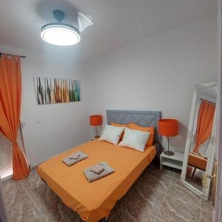 a bedroom with a bed with two towels on it at CASA LUTHI Costa Blanca in Orihuela Costa
