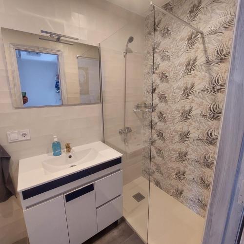 a white bathroom with a shower and a sink at CASA LUTHI Costa Blanca in Orihuela Costa