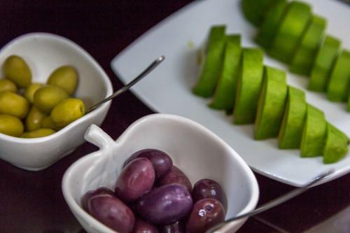 a table topped with bowls of grapes and green apples at Illa Hotel in Cusco