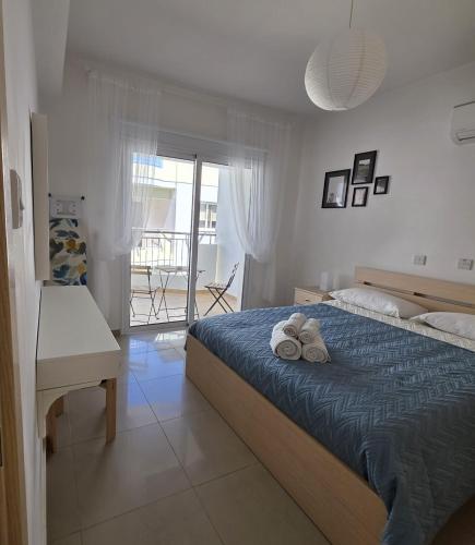 a bedroom with a bed with two towels on it at Obv 2-303 in Pyla