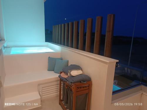 a room with a balcony with a table and a chair at Blue Aura Beach villa Larnaca in Perivolia