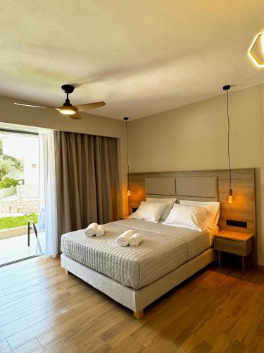 a bedroom with a bed with two towels on it at Celene Luxury Plakias in Plakias