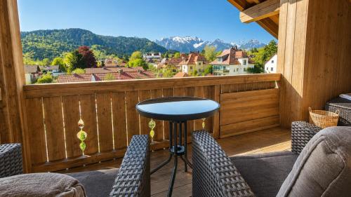 a balcony with chairs and a table and a view at Hotel Filser in Füssen