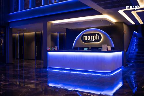a lobby with a morrill sign on the wall at morph Bangkok Hotel in Bangkok