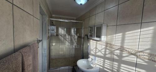 a bathroom with a sink and a toilet at 54 on Asteria 2 in Amanzimtoti