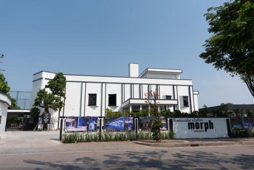 a white building with a fence in front of it at morph Bangkok Hotel in Bangkok