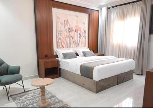 a bedroom with a large bed and a chair at شقق سكنية بالخالدية in Al ‘Awālī