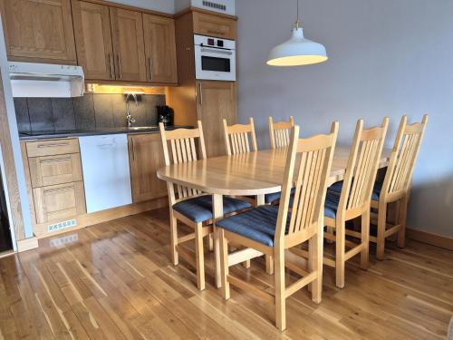 a kitchen with a wooden table and chairs at AGO Nya Lundsgården in Åre