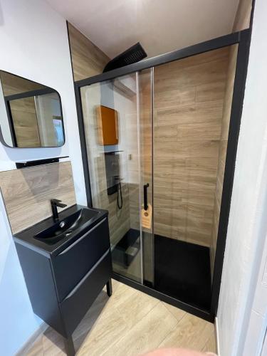 a bathroom with a black sink and a shower at Carro Zen in Martigues