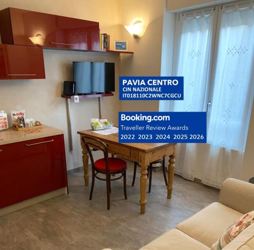 a kitchen with a table with a sign that reads ravina centre in melbourne at PAVIA CENTRO in Pavia