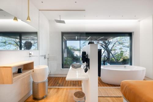 a bathroom with a tub and a large window at Villa Liquen in Yaiza
