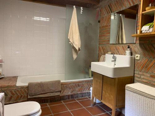 a bathroom with a sink and a tub and a toilet at Ermita de la Tuda-Villaescusa de las Torres in Villaescusa de las Torres