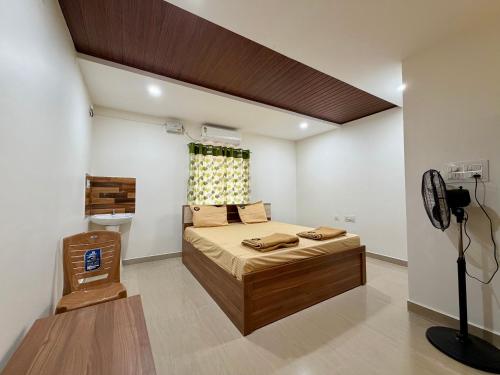 a bedroom with a large bed in a room at AR Cottage in Udupi