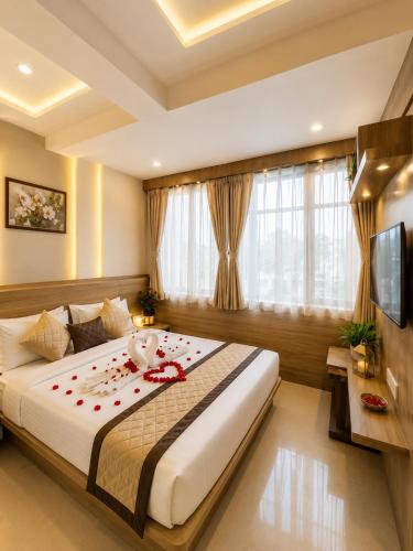 a bedroom with a large bed with flowers on it at Hotel Royal Blue in Modāsa