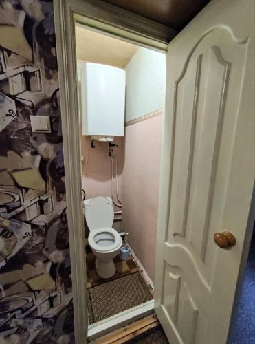 a small bathroom with a toilet in a room at Apartment on Y. Mudroho 44 in Bila Tserkva