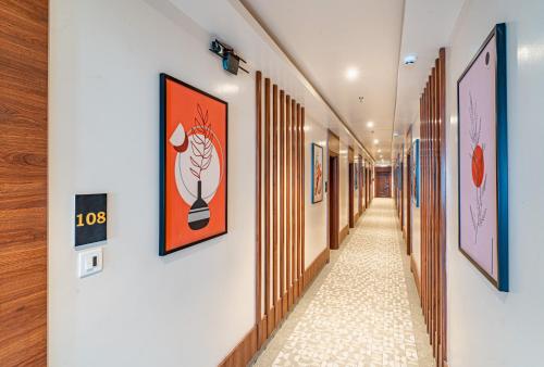 a corridor in a building with paintings on the walls at Hotel Chand Ratan Palace By Travinities in Bikaner