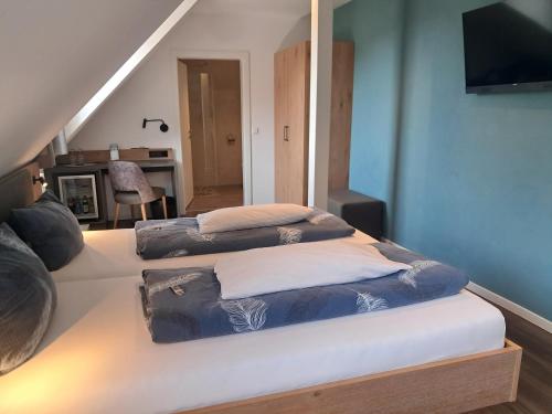 two beds sitting on a bed in a room at Hotel Hirsch in Sinsheim