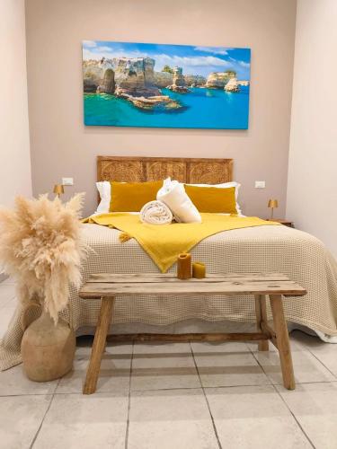 a bedroom with a bed with a yellow bedspread at "Il Vecchio Salone" appartamento in pieno centro con garage privato in Lecce