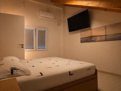 a bedroom with a bed and a flat screen tv at Nortra apartment in Tolmin