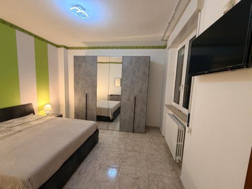 a bedroom with a bed and a television in it at House raffy in San Severo