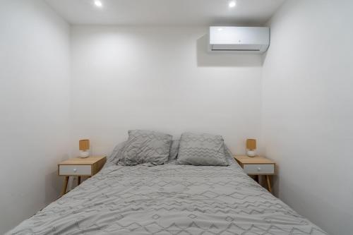 a bedroom with a bed and two night stands at Port-la-Nouvelle 4p in Port-la-Nouvelle