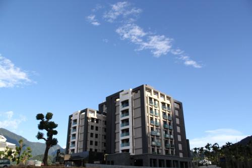 a tall apartment building with a tree in front of it at Fantasy Palace in Yuchi