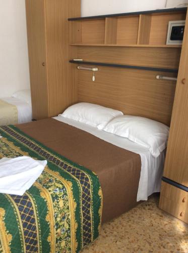 ein kleines Schlafzimmer mit zwei Betten in einem Zimmer in der Unterkunft Hotel Gino in Noli