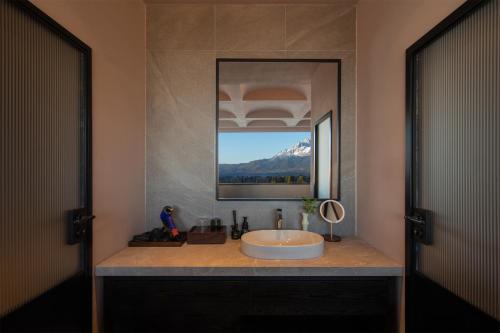 a bathroom with a sink and a mirror at Lijiang Chenxi View Hotel in Lijiang