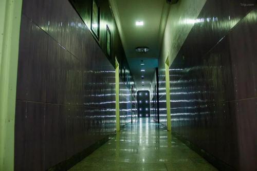 a dark hallway with a chair in a building at Emglo Suite in Lagos