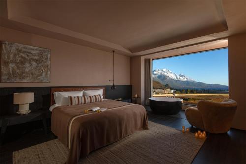 a bedroom with a bed and a tub and a window at Lijiang Chenxi View Hotel in Lijiang