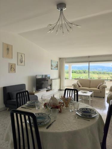 a dining room table with chairs and a living room at Villa Thalea in Diano Marina