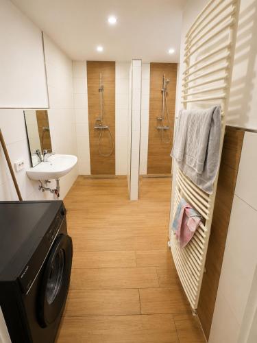 a bathroom with a sink and a washing machine in it at Apartment Rahden in Rahden