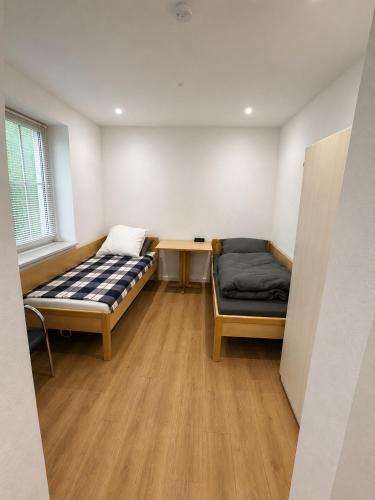 a room with two beds and a desk and a table at Apartment Rahden in Rahden