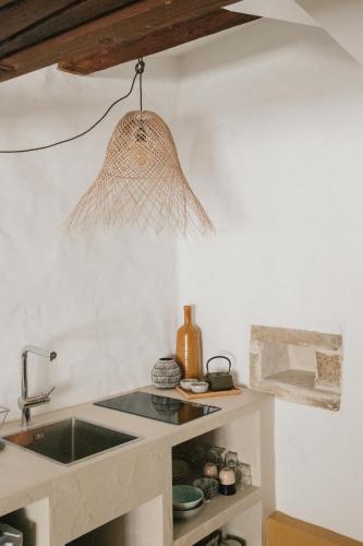 a kitchen with a sink and a pendant light at Flusshaus BnB Okavango in Brugg
