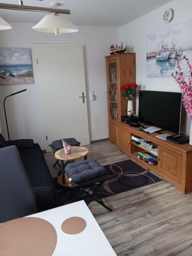 a living room with a couch and a tv at Ferienwohnung Benzmann in Süderbrarup