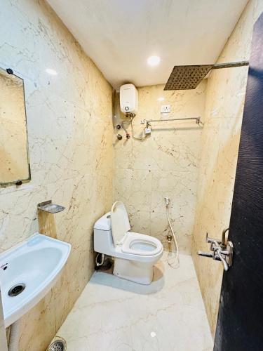 a bathroom with a toilet and a sink at Hotel Sunview in Kolkata