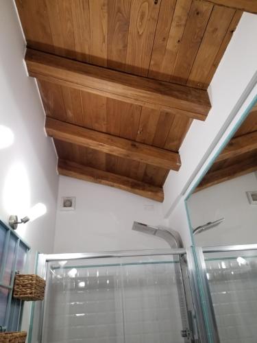 a bathroom with a shower and a wooden ceiling at La Palma in Lerici