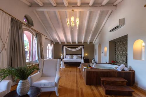 a large bathroom with a tub and a bed at Oliviera Private Island Hotel - Kalem Island in Kalem Adasi