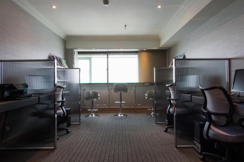 an empty office with chairs and desks and a window at Santos Hotel in Taipei