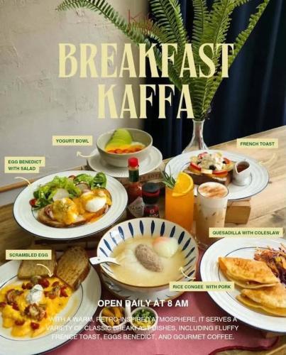 a table with plates of breakfast food on it at Josh Hotel in Bangkok