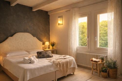 a bedroom with a bed with two towels on it at Locanda Divinis in Cerea