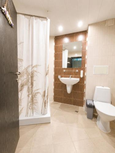 a bathroom with a toilet and a sink and a shower at Decor in Atlantis Resort&SPA by RV Apartments in Burgas