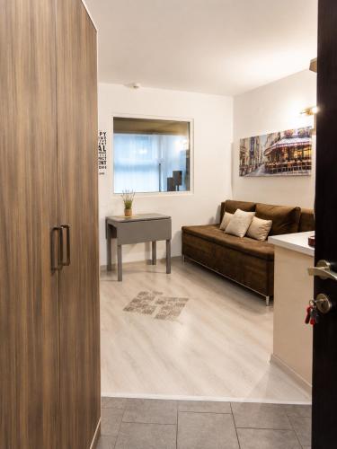 a living room with a couch and a table at Decor in Atlantis Resort&SPA by RV Apartments in Burgas