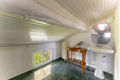 a bathroom with a sink and a mirror at La dolce riva - lake Cottage in Onno