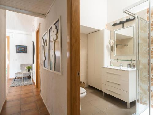 a bathroom with a toilet and a sink at Oasis Beach Holiday Home with jacuzzi in Playa del Ingles