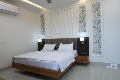 a bedroom with a bed with white sheets and a window at Radiant Inn in Morena